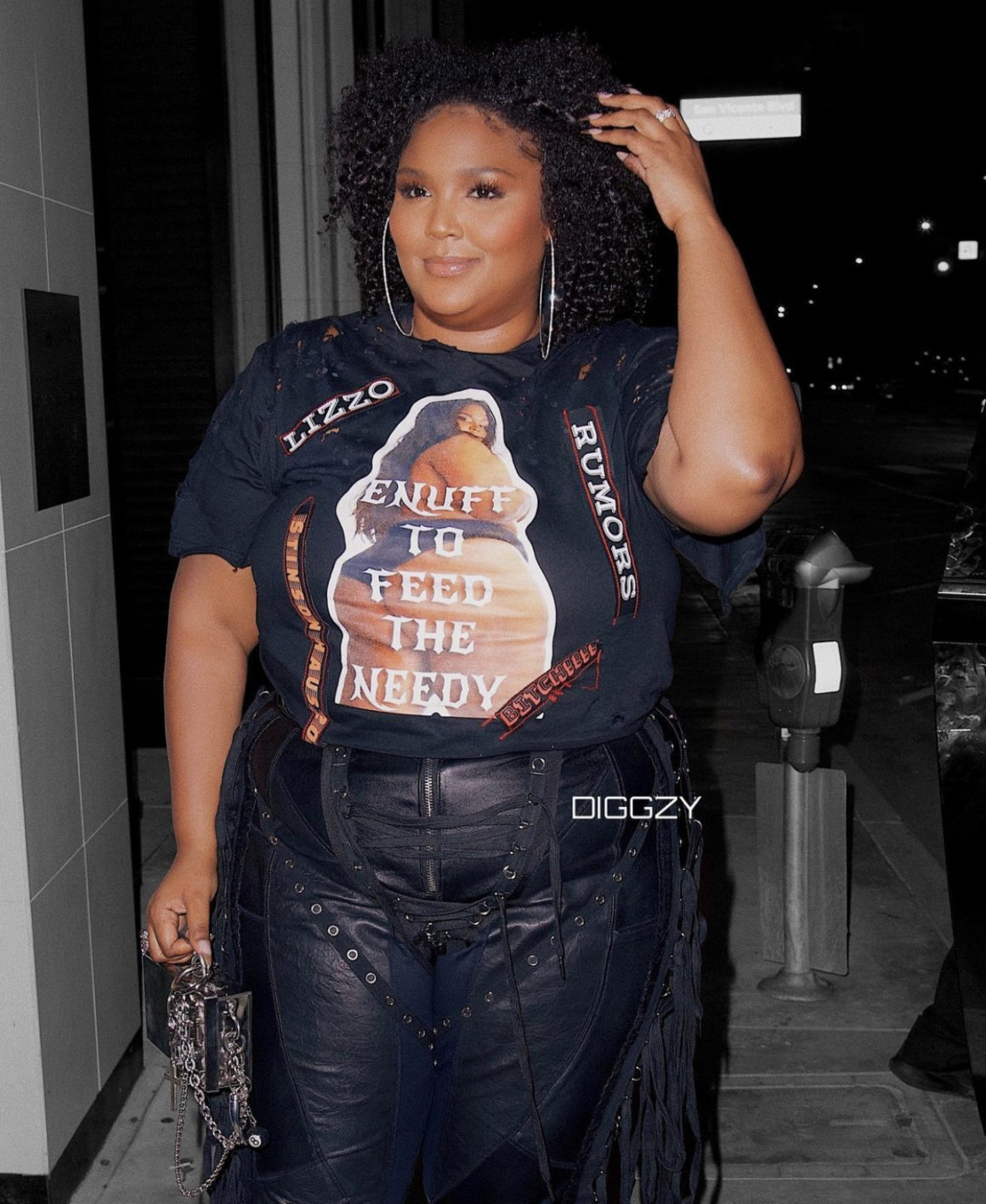 Lizzo Lets Us Know the Rumors Are True in Custom Black Stinson Haus Look Including Graphic T-Shirt and Leather Fringe Pants Lizzo Lets Us Know the Rumors Are True in Custom Black Stinson Haus Look Including Graphic T-Shirt and Leather Fringe Pants
